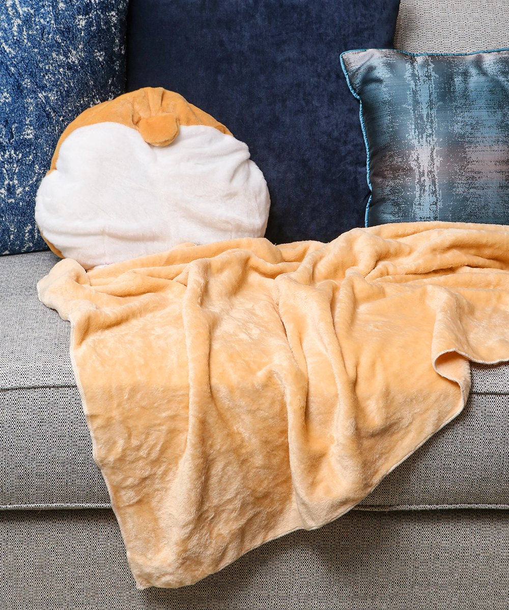 Giant Corgi Butt 3-in-1 Pillow / Hand Warmer / Blanket on couch with blanket