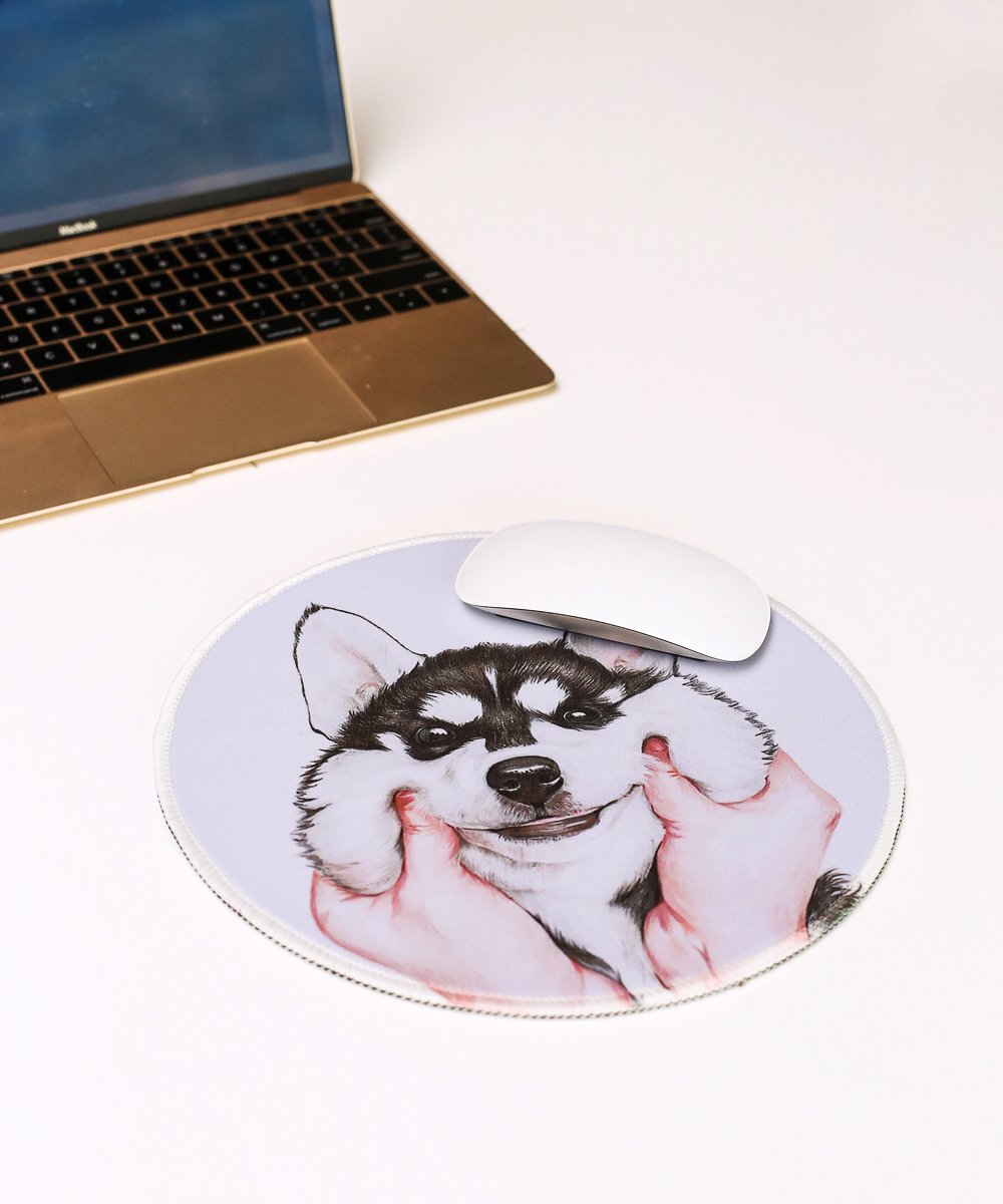 Husky Cheeks Mouse Pad next to computer