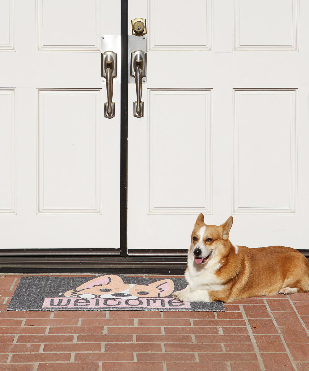 Black and Pink Welcome Home Corgi Non-slip Outdoor Doormat With Corgi Laying On Top Next To Front Door