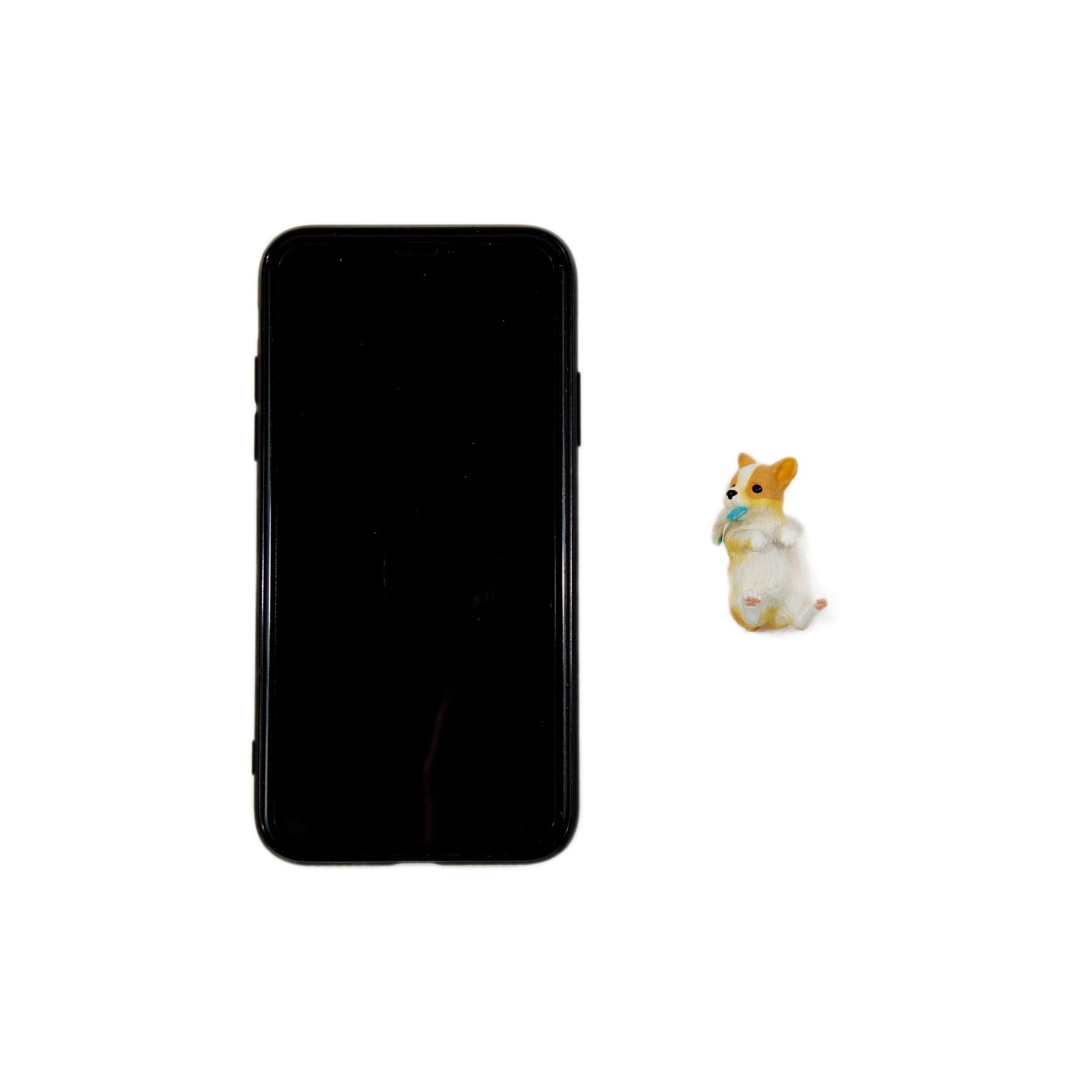 Corgi Miniature next to cellphone for size comparison