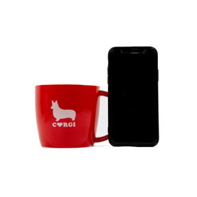 Red Corgi Mug next to cellphone for size comparison